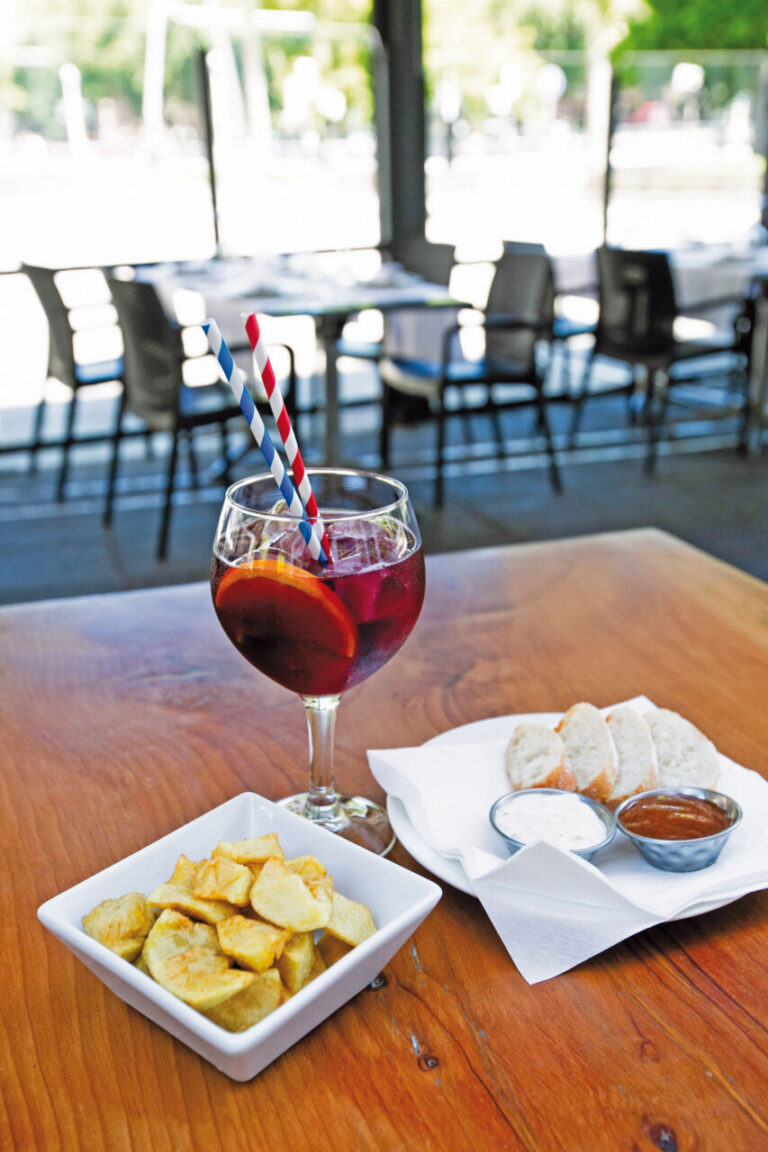 Plato de comida mediterránea con bebida en terraza de Larruzz Bilbao
